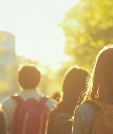 A group of students walking to class with backpacks