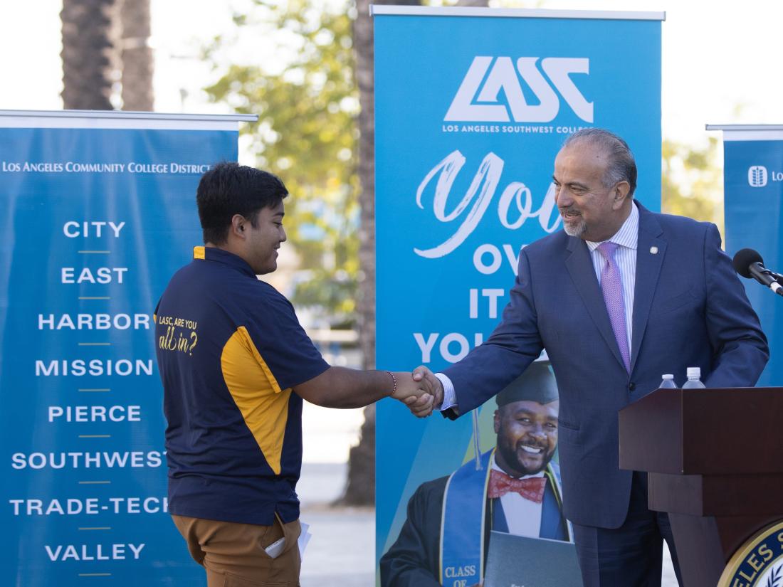 LACCD Chancellor Francisco Rodriguez Shakes Hands with a Student at a LA Southwest College Event