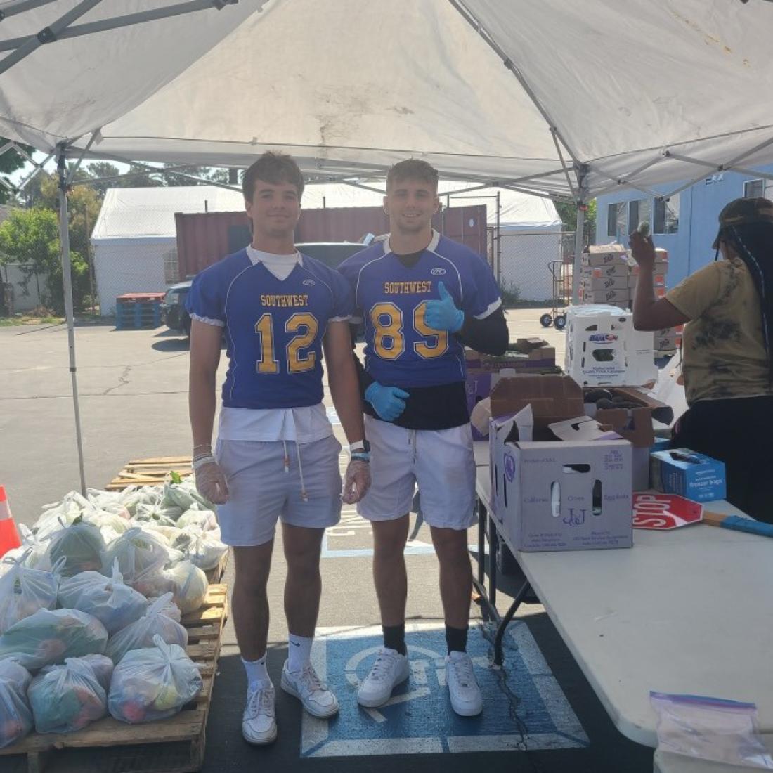 LASC Cougar Football team passing out food to those in need at The Great Grocery Giveaway