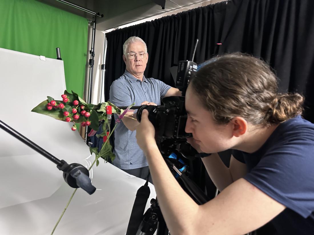 Raquel G. Frohlich gets an assist from Pierce Media Arts alumni Joey Terrill, a commercial photographer as she photographs plants in the studio at Pierce College in Woodland Hills, Calif.