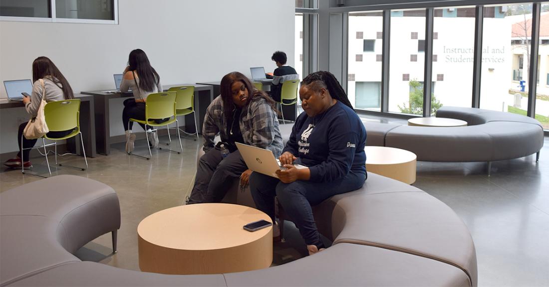 A financial aid technician assisting a student with their financial aid application