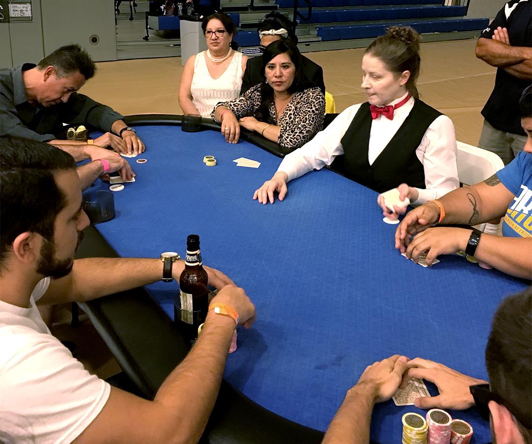 A group of men and women playing poker at a poker tournament