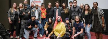 LACC students and Producer Ira Rosen centered